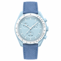 Light blue chronograph watch with blue suede strap on white background
