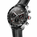 Chronograph watch with black dial, black leather strap, and silver stainless steel case on white background