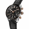 Chronograph watch with black dial, rose gold accents, and black leather strap on white background