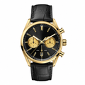Gold tone dress chronograph watch with black dial and black leather strap on white background