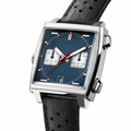 Chronograph racing style watch with blue dial and black perforated leather strap on white background